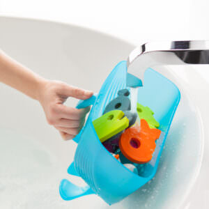 Rinsing children's bath toys after scooping with the Boon Whale Pod.
