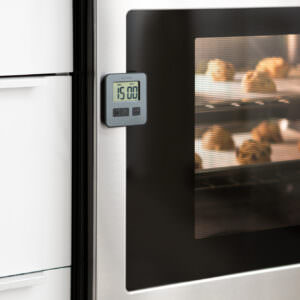 Lifestyle image of cookies baking in the oven with an external thermometer product.