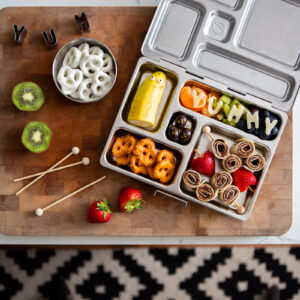 Lunchbox product styled with themed food featuring the word yummy made of food.