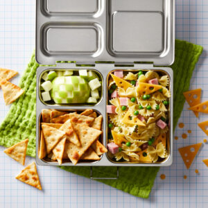 Geometric themed food in a stainless steel, reusable lunchbox.