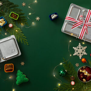 Reusable, environmentally friendly lunchboxes in a holiday themed setting for the gift giving season.