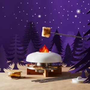 Custom built night time camping scene displaying a s'mores making product.