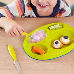 Toddler plate and utensils product photographed with child model.